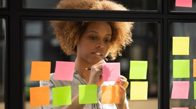 woman keeping track on sticky notes